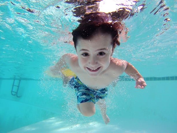 family-friendly-central-florida-neighborhoods-orlando-suburbs-bellalago-child-swimming.jpg